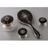 A silver and tortoiseshell piquet part dressing table set to include a hand mirror, dressing table