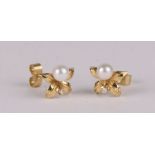 A pair of 18ct gold pearl and diamond stud earrings, 2.2g.