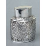 An Eastern white metal tea caddy with foliate decoration, 9.5cms high, 102g.