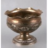 An Indian white metal pedestal bowl decorated in relief with animals, 10cms high.