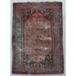 A Persian rug with stylised animals and flowers within multi borders, on a red ground, 128 by