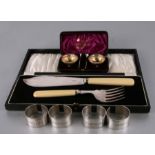 A pair of silver open salts with gilded interior and associated spoons, cased; together with a