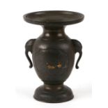 A Japanese bronze and mixed metal vase with stylised elephant handles, 14cms high.