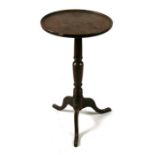 A 19th century mahogany wine table on turned column and tripod base, 40cms diameter.