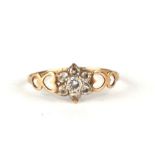 A 9ct gold white stone cluster ring with ornate pieced heart shoulders, approx UK size 'S', 1.2g.