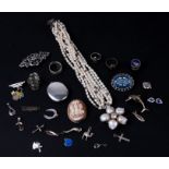 A quantity of silver and costume jewellery to include a locket and a cameo brooch.