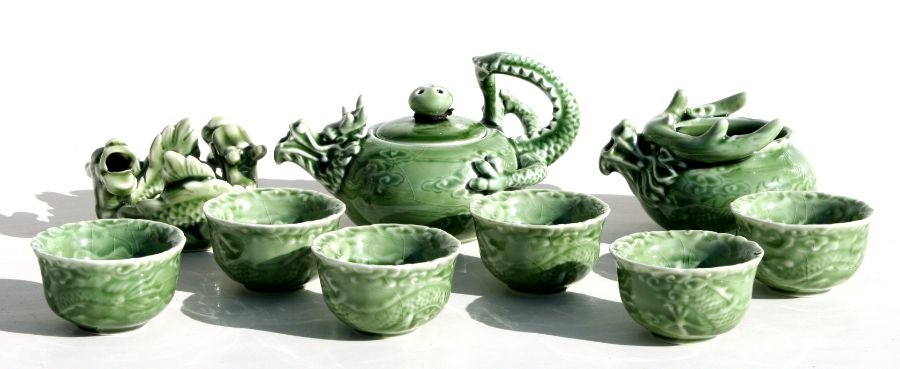A Chinese green glazed tea set with dragon decoration.