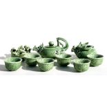 A Chinese green glazed tea set with dragon decoration.