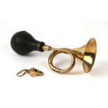 A reproduction brass single bend car horn, 28cm long, together with a brass whist key ring.( 2)