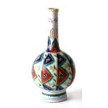 A Turkish Kutahya bottle vase decorated with flowers and geometric patterns, 25cms high.