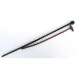 A hardwood walking cane with figural terminal, 80cms long; together with with a treen swagger