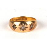 An 18ct gold gypsy ring set with three diamonds, approx UK size 'L', 2.4g.