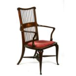 An Art Nouveau inlaid mahogany elbow chair with upholstered seat.