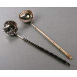 Two antique white metal toddy ladles, one with bone handle, one with baleen, 28cms long (2).