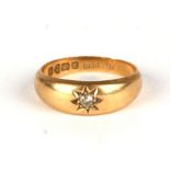 An 18ct gold gypsy ring set with a solitaire diamond, approx UK size 'M', 4.2g.
