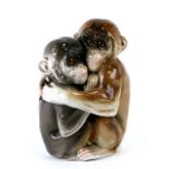 A Capodimonte porcelain nightlight in the form of intertwined monkeys with glass eyes, 24cms high.