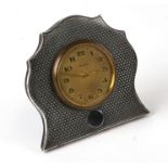 A silver mounted 8-day strut clock with indistinct Birmingham hallmarks, 9.5cms high.
