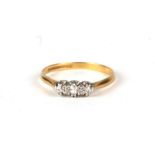 An 18ct gold and platinum three-stone diamond ring, approx UK size 'Q', 2.5g.