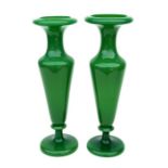 A pair of slender green glass vases with snapped off pontil mark, 37cms high.