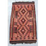 A North African flat weave rug with geometric designs on a red ground, 172 by 100cms.