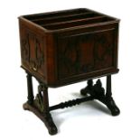 A 19th century rosewood three-division Canterbury on turned twin supports joined by a stretcher,