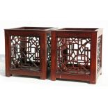 A pair of Chinese style hardwood pierced planters, 28cms high (2).
