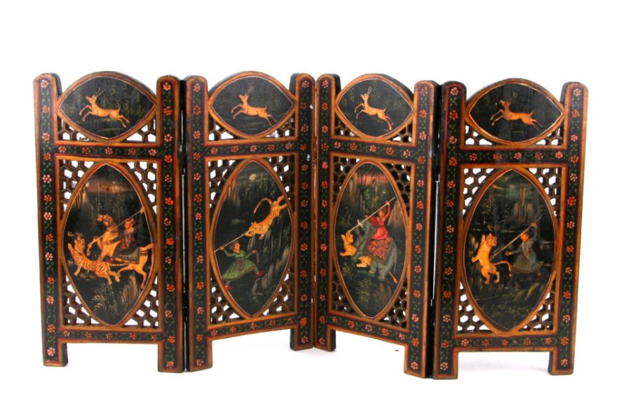 An Indo-Persian pierced four-fold miniature table screen decorated with tiger hunt scenes within a