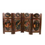 An Indo-Persian pierced four-fold miniature table screen decorated with tiger hunt scenes within a