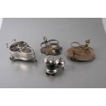 Four Victorian silver plated novelty cruet stands, one in the form of curling stones.