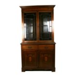 An Edwardian inlaid mahogany bookcase on cupboard, the astragal glazed upper section enclosing a