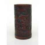 A Chinese bamboo brush pot decorated with figures in a landscape, 12cms high.