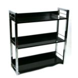 A modern design three-tier open bookcase on chrome plated supports, 77cms wide.