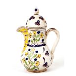 A Turkish Kutahya coffee pot decorated with flowers, 20cms high.
