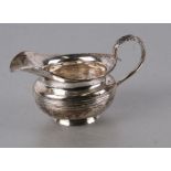 A William IV Irish silver cream jug, Dublin 1835 and makers mark for James le Bas, 8cms high 128g.