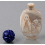 A Chinese mother of pearl snuff bottle carved with a dragon and two figures, 6cms high; together