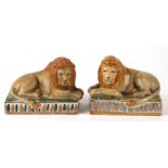 A pair of Staffordshire style pottery recumbent lions, 15cms wide (2).