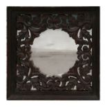 A square wall mirror within a pierced walnut foliate scrolling frame, 40 by 40cms.Condition