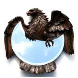 A Black Forest carved walnut wall mirror in the form of an eagle with out swept wings with