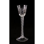 A Georgian wine glass with double helix opaque air twist stem and flowers engraved to the bowl,