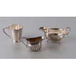 A Walker & Hall silver sauce boat, Birmingham 1925; together with a silver cream jug, Sheffield