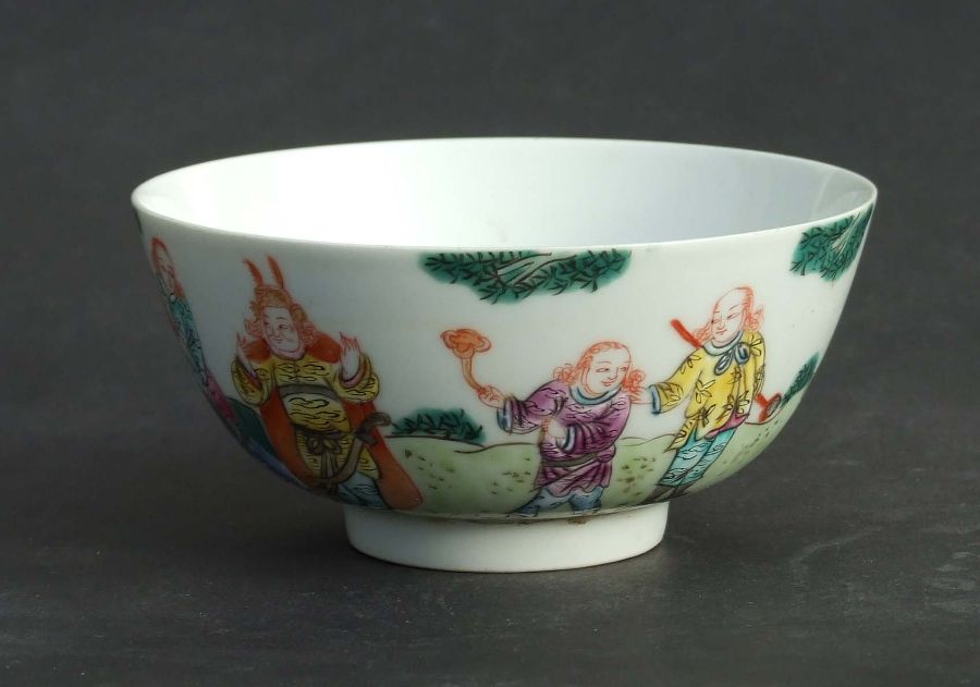 A Chinese famille rose bowl decorated with figures in a landscape, red seal mark to the underside,