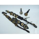 A quantity of vintage horse brasses mounted on leather straps.