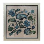 An embroidered wool work panel on linen depicting scrolling blue flowers, framed & glazed, 55 by