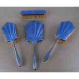 An Art Deco silver and blue guilloche enamel dressing table set comprising three brushes and a