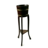 An oak coopered barrel form jardiniere, 91cms high.