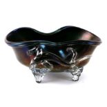A shaped iridescent lustre glass bowl with applied clear glass lizard feet, and ground out pontil