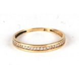 A 9ct gold half eternity ring set with white stones, approx UK size 'R'.