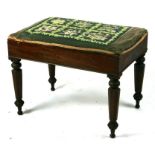 A William IV mahogany stool with embroidered panel above octagonal tapering legs, 62cms wide.