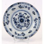 A Delft blue & white plate decorated with flowers, 23cms diameter.