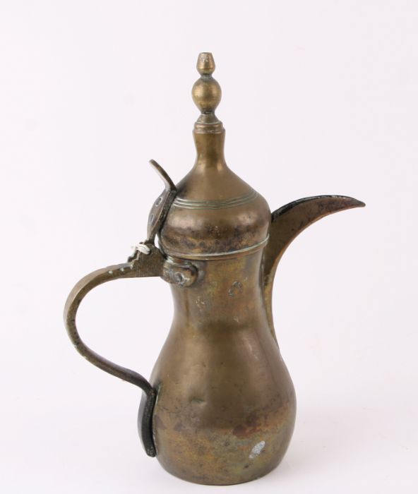 A Turkish / Islamic brass dallah coffee pot, 31cms high.